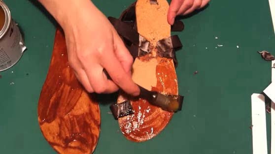 placing the glue on entire surfaces of the sandal's insole and sole