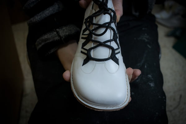Barefoot minimalist shoe being hand-sewn